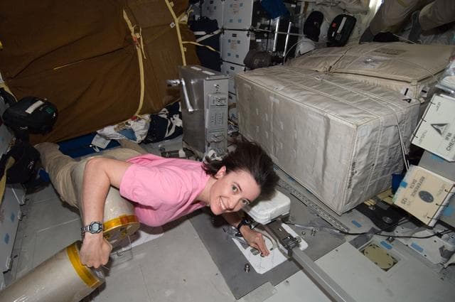 NASA image: STS-125 MS2 McArthur works with the LiOH Cannisters on the Middeck