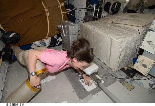 NASA image: STS-125 MS2 McArthur works with the LiOH Cannisters on the Middeck