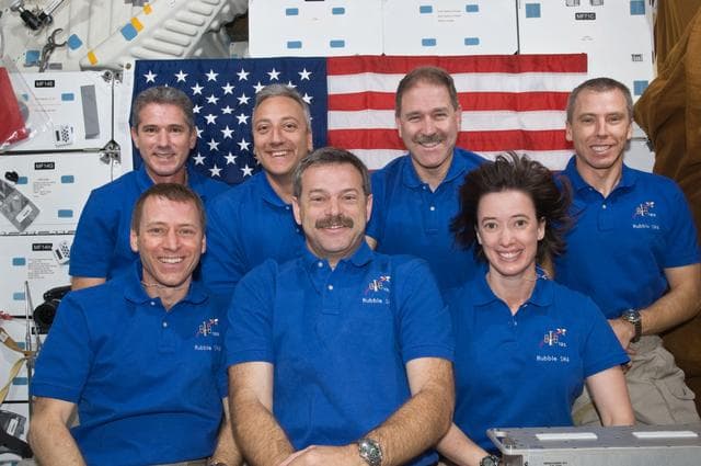 NASA image: STS-125 Crew Members pose for a crew portrait on Atlantis' Middeck