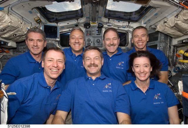 NASA image: STS-125 Crew Members pose for a photo on the Flight Deck