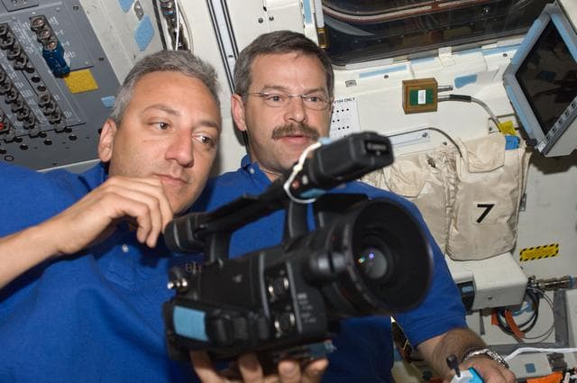 NASA image: View of STS-125 Crew Members working with a Video Camera
