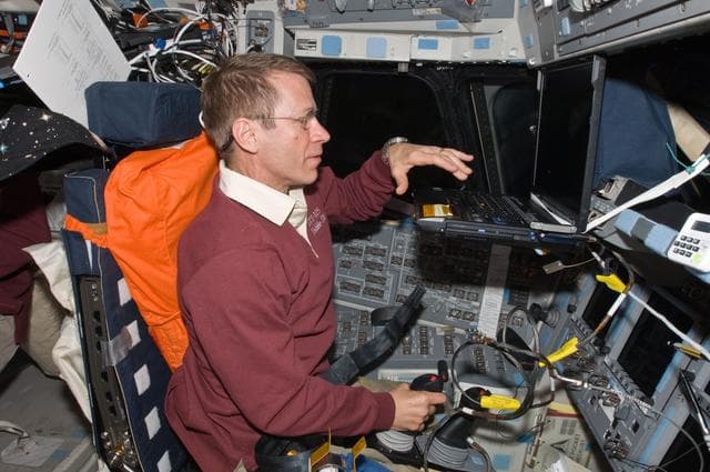 NASA image: View of Pilot Gregory Johnson working on the Flight Deck