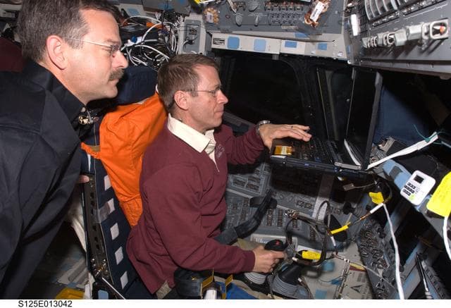 NASA image: View of Pilot Gregory Johnson working on the Flight Deck