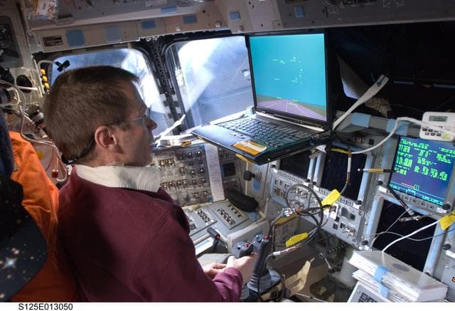 NASA image: View of STS-125 Crew Members working on the Flight Deck