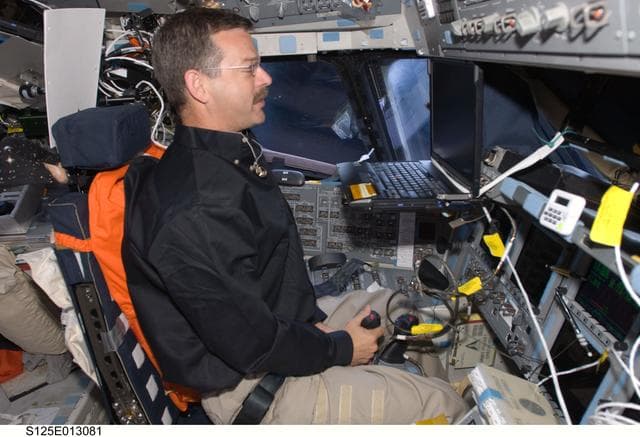 NASA image: View of Commander (CDR) Scott Altman working on the Flight Deck