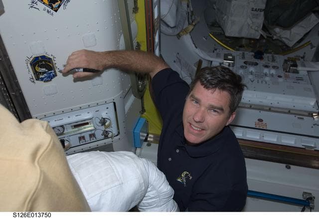 NASA image: Bowen signs Mission Patch in A/L