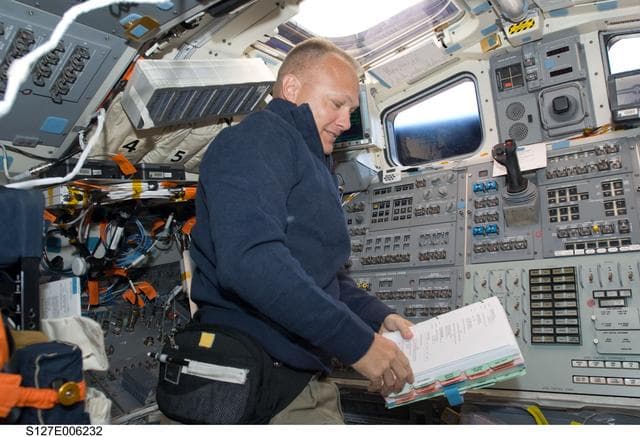 NASA image: Hurley looks at procedures in the aft FD on the Space Shuttle Endeavour during the STS-127 Mission