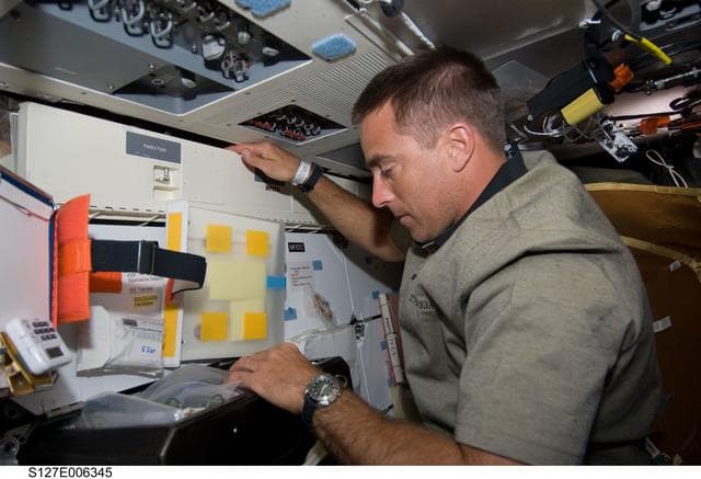 NASA image: Cassidy working in the FWD MDDK on the Space Shuttle Endeavour during the STS-127 Mission