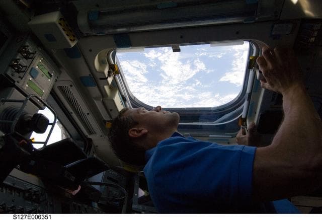 NASA image: Cassidy looks out window in the aft FD on the Space Shuttle Endeavour during the STS-127 Mission