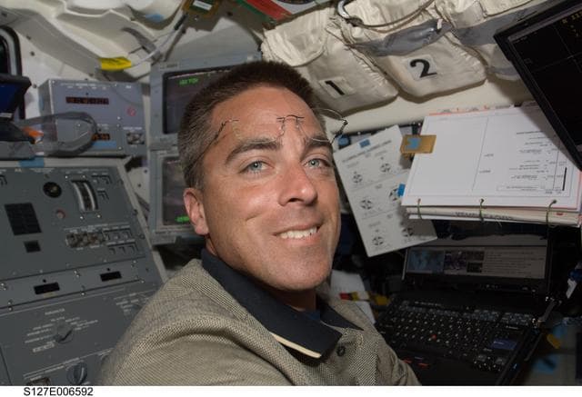 NASA image: Cassidy in the aft FD during docking activities of Space Shuttle Endeavour