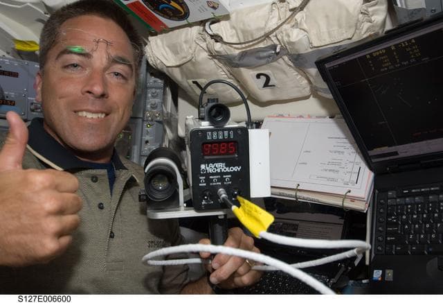 NASA image: Cassidy gives the thumbs up in the aft FD during docking activities of Space Shuttle Endeavour