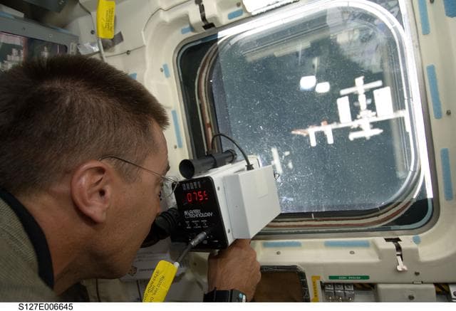 NASA image: Cassidy uses Laser Ranging Device in the aft FD during docking activities of Space Shuttle Endeavour
