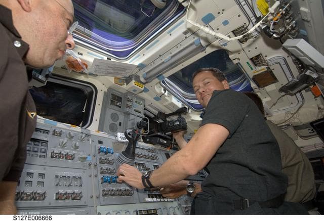 NASA image: Polansky, Marshburn, and Cassidy in the aft FD during docking activities of Space Shuttle Endeavour
