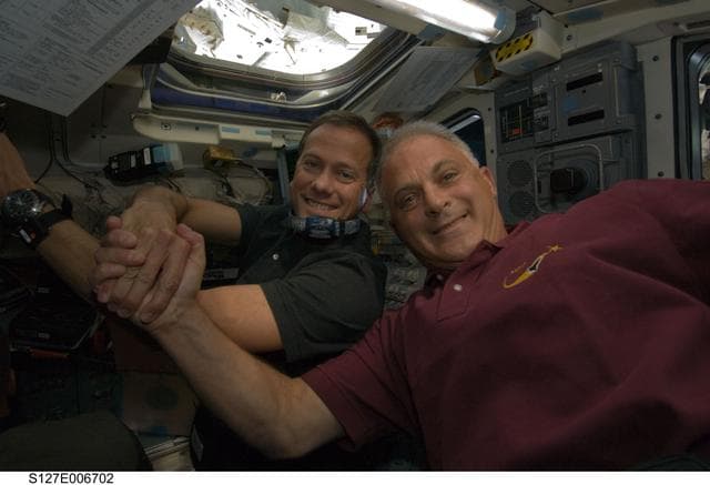 NASA image: Marshburn and Wolf celebrate docking in the aft FD during STS-127 Mission