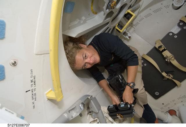 NASA image: Payette holds camera in the A/L after docking with ISS during STS-127 Mission
