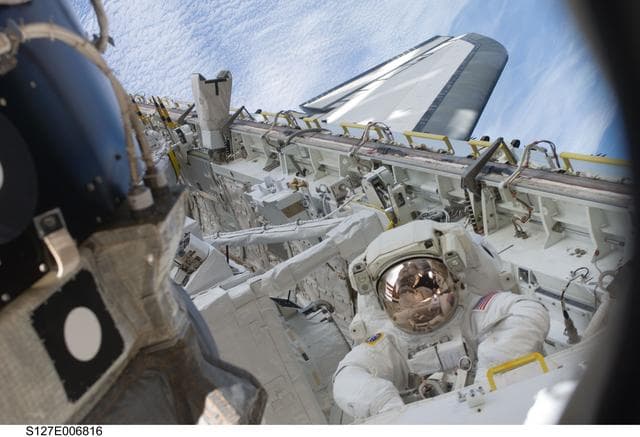 NASA image: Kopra in Endeavours Payload Cargo Bay during EVA-1 on STS-127 / Expedition 20 Joint Operations