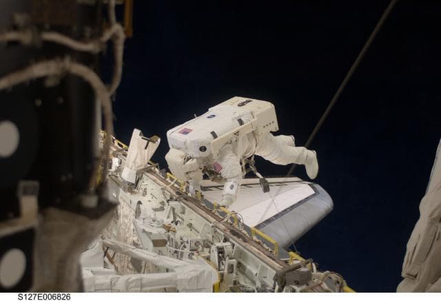 NASA image: Kopra in Endeavours Payload Cargo Bay during EVA-1 on STS-127 / Expedition 20 Joint Operations