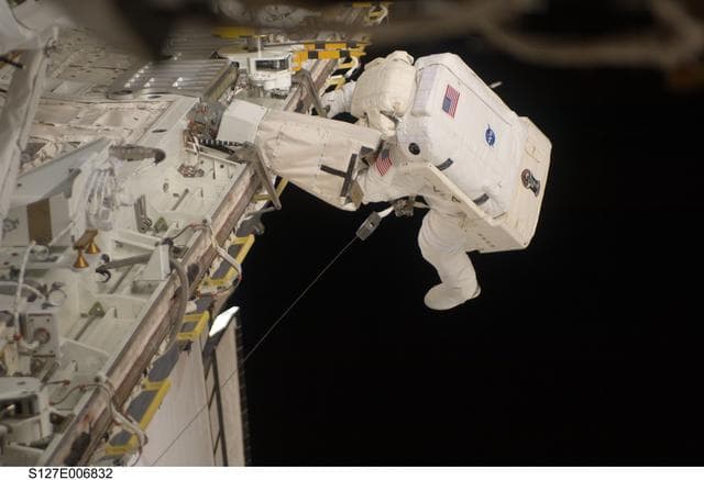 NASA image: Kopra in Endeavours Payload Cargo Bay during EVA-1 on STS-127 / Expedition 20 Joint Operations