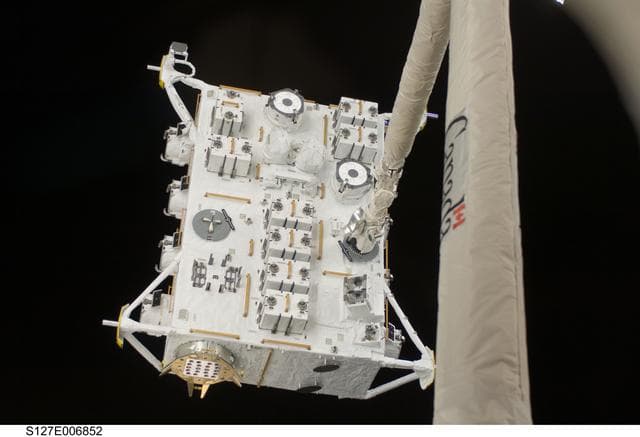 NASA image: SRMS moves JEF during EVA-1 on STS-127 / Expedition 20 Joint Operations