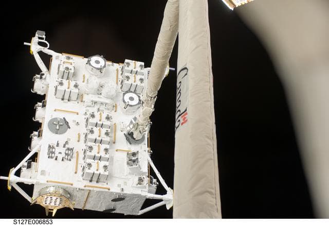 NASA image: SRMS moves JEF during EVA-1 on STS-127 / Expedition 20 Joint Operations