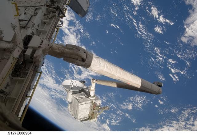 NASA image: SRMS maneuvers the ICC-VLD during STS-127 / Expedition 20 Joint Operations
