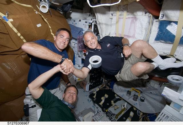 NASA image: Cassidy,Marshburn,and Wolf in the MDDK during STS-127 / Expedition 20 Joint Operations