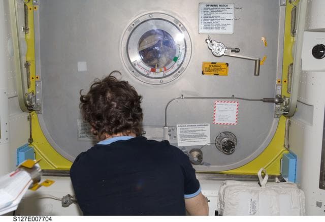NASA image: Barratt closes Crew Lock of the A/L during EVA-3 Preparation
