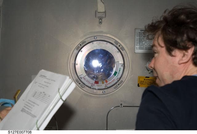 NASA image: Barratt near Crew Lock hatch in the A/L during Joint Operations