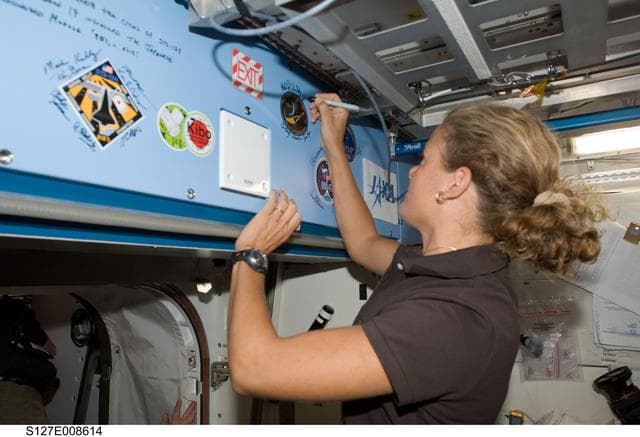 NASA image: Payette signs mission decal in the JEM during Joint Operations