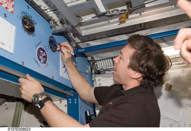 NASA image: Barratt signs mission decal in the JEM during Joint Operations
