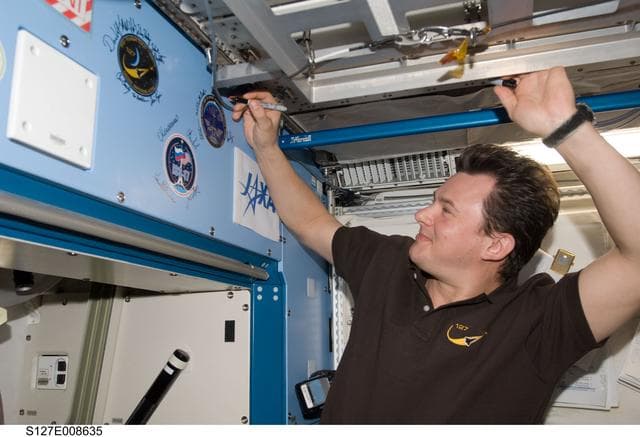 NASA image: Romanenko signs mission decal in the JEM during Joint Operations