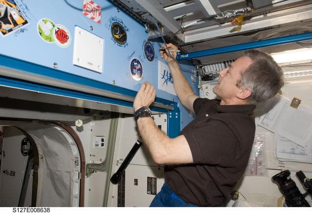 NASA image: Thirsk signs mission decal in the JEM during Joint Operations
