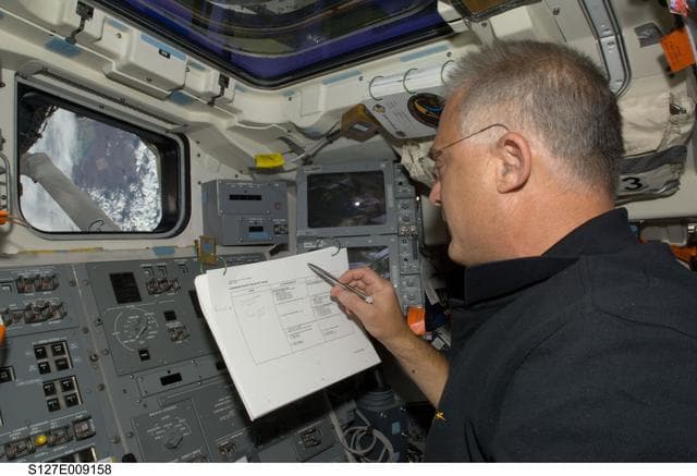 NASA image: Wolf looks at crew procedures in the aft FD of Endeavour during Joint Operations