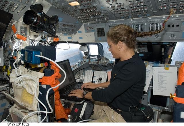 NASA image: Payette uses computer in the aft FD on Space Shuttle Endeavour