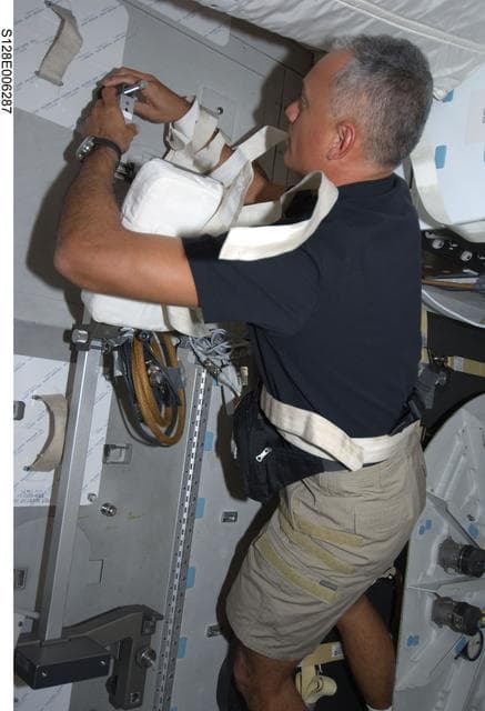 NASA image: Olivas works with harness on Middeck (MDDK) during STS-128