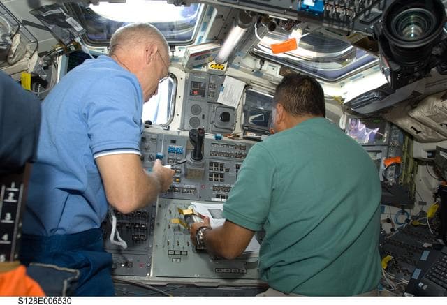 NASA image: Forrester and Hernandez on Flight Deck (FD) during OBSS OPS