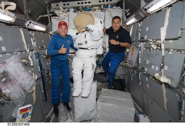 NASA image: Sturckow poses with EMU in MPLM