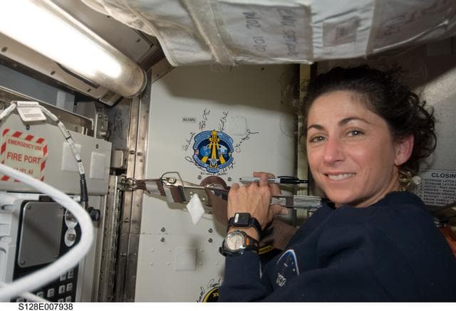 NASA image: Stott signs crew patch in Joint Airlock