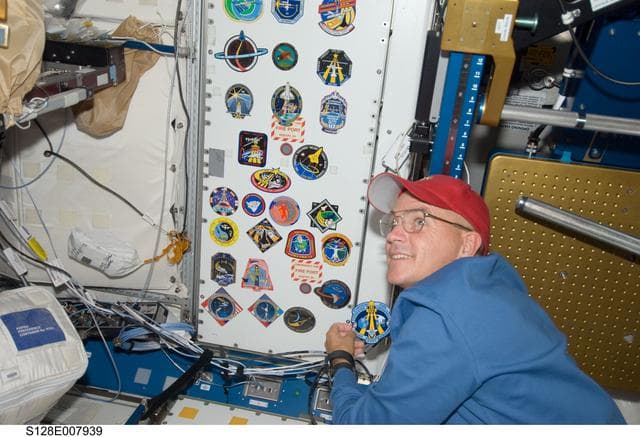 NASA image: Sturckow adds STS-128 crew patch to wall in Node 1 Unity