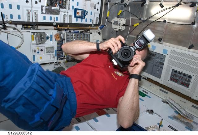 NASA image: View of CDR Hobaugh working on the Middeck