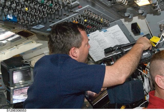 NASA image: STS-129 MS3 Foreman works with a Video Camera on the FD