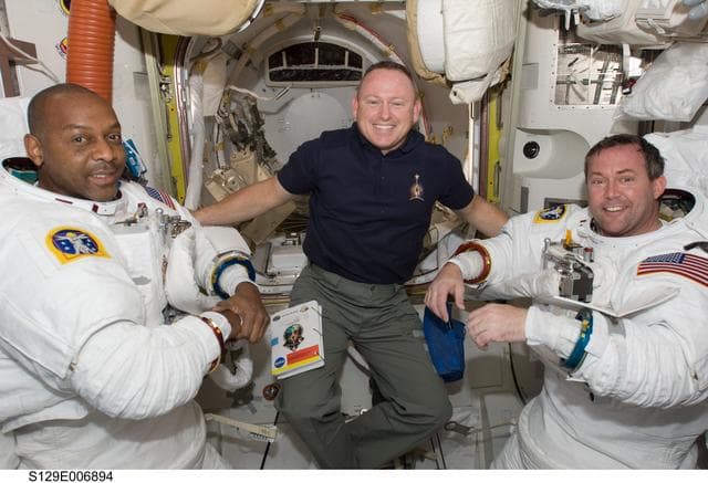 NASA image: STS-129 Crew Members pose for a photo in the Airlock