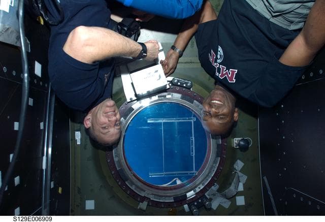 NASA image: STS-129 Crew Members posing for a photo in the US Lab