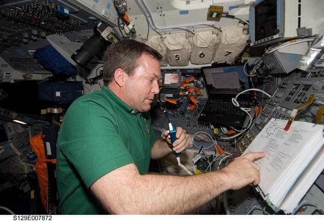 NASA image: STS-129 MS3 Foreman monitors EVA3 from the Atlantis Flight Deck