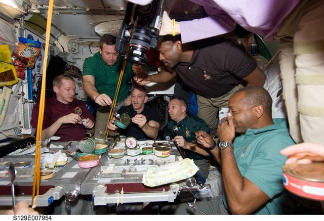 NASA image: STS-129/Expedition 21 Crew Members enjoy a meal together in the Node 1
