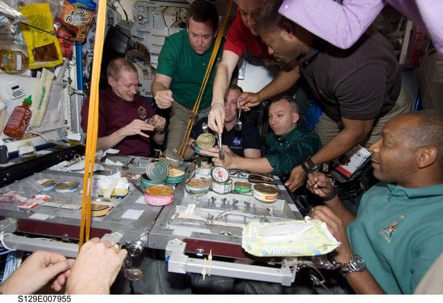 NASA image: STS-129/Expedition 21 Crew Members enjoy a meal together in the Node 1