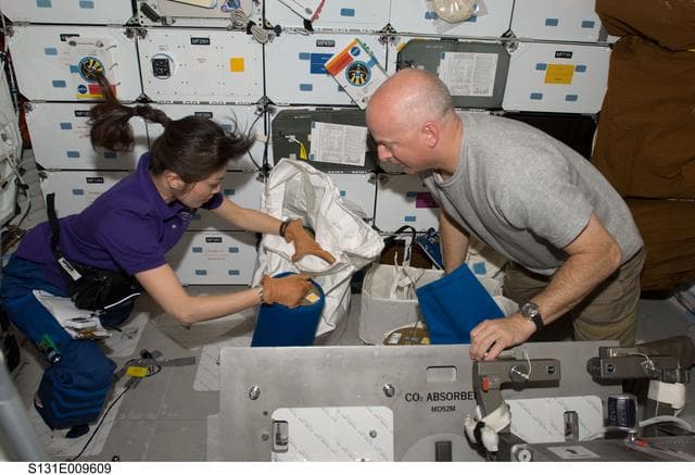 NASA image: Poindexter and Yamazaki with LIOH Canisters