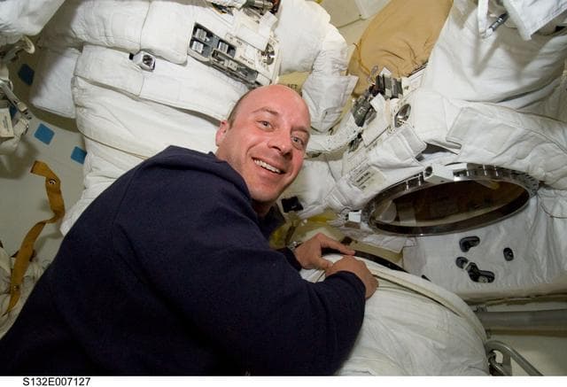 NASA image: Reisman works on EMU Spacesuit in the MDDK during STS-132