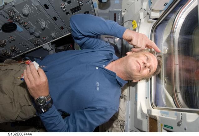 NASA image: Sellers looks out window in the aft FD on Space Shuttle Atlantis
