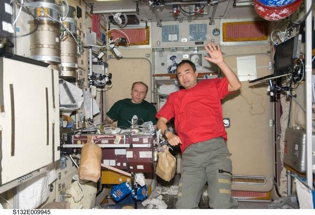 NASA image: Kotov and Noguchi enjoy a meal in the SM during Joint Operations